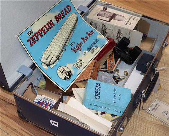 A vintage globetrotter case containing assorted ephemera to include glamour photo booklets, enamel sign etc.